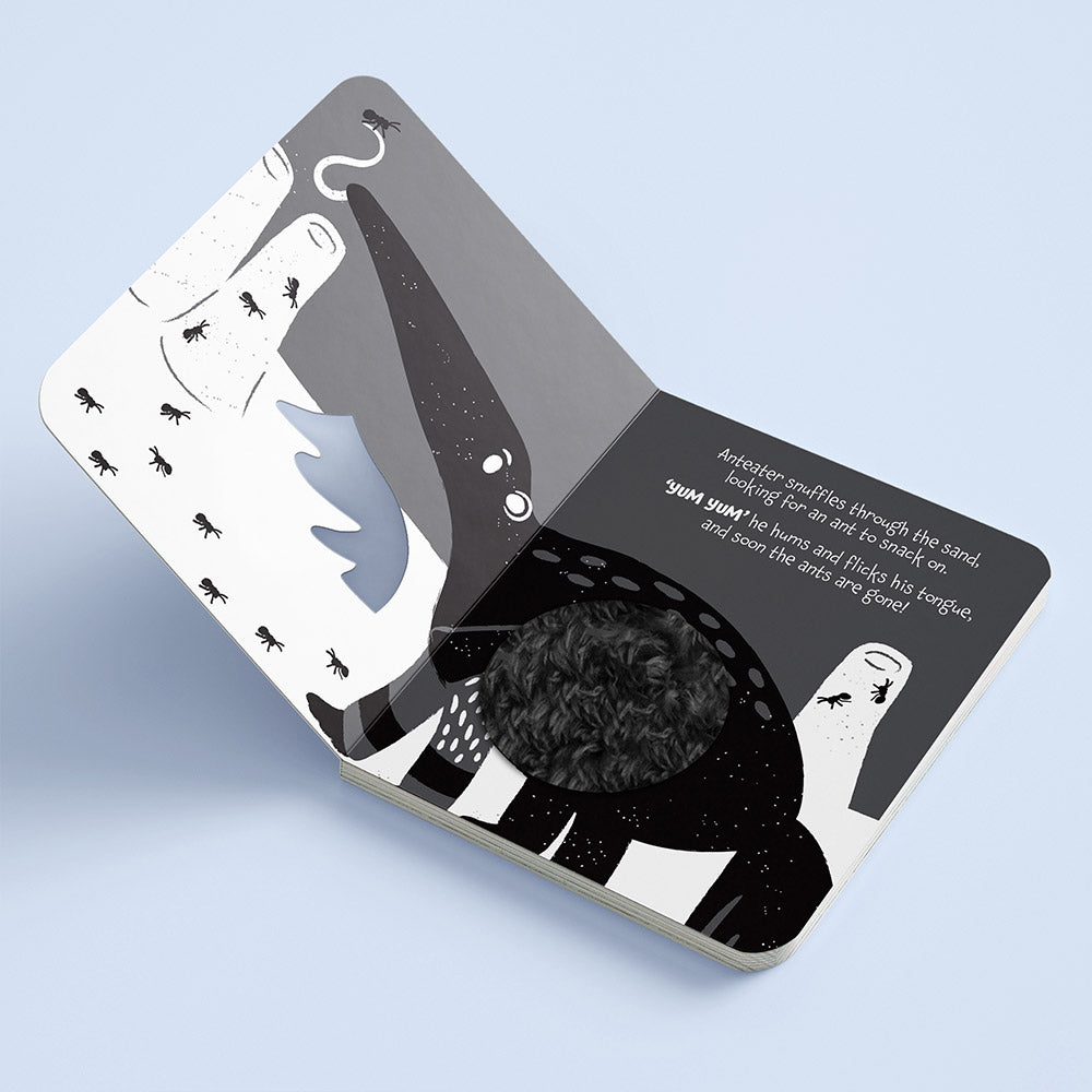 Illustrated children's book open to a page with a whale illustration. High Contrast Board Book Touch and Feel: Rawr Rawr! for baby. MOD & TOD